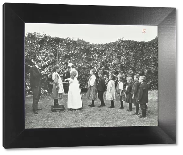 Children being weighed in the garden, Montpelier House Open Air School, London, 1908