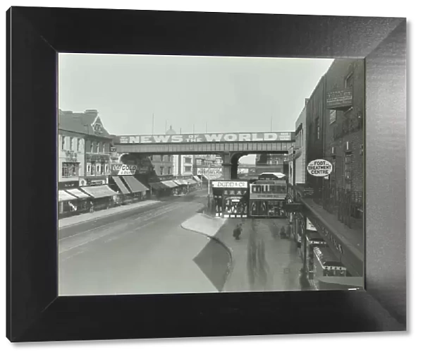 Railway bridge and advertising over the Brixton Road, Lambeth, London, 1938