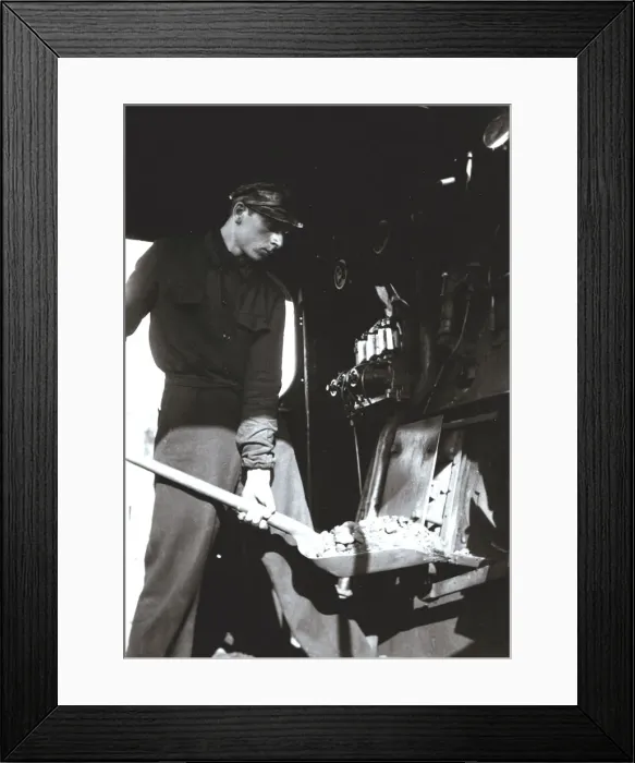 Framed Print : Stoker putting coal to a steam train engine Framed Print : Stoker putting coal to a steam train engine