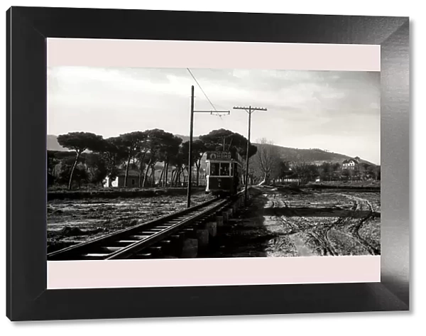 Argentona Mataro Tram crossing the pontoon on the river of Argentona, on a postcard