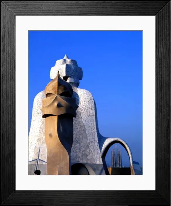 Framed Print : Detail of the chimneys of La Pedrera or Mila House with the Sagrada Familia at background Framed Print : Detail of the chimneys of La Pedrera or Mila House with the Sagrada Familia at background