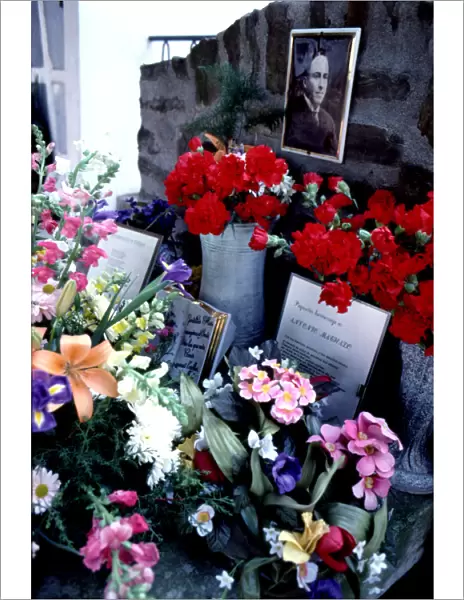 Flower-filled tomb in the cemetery of Cotlliure with the picture of Antonio Machado (1875-1939)