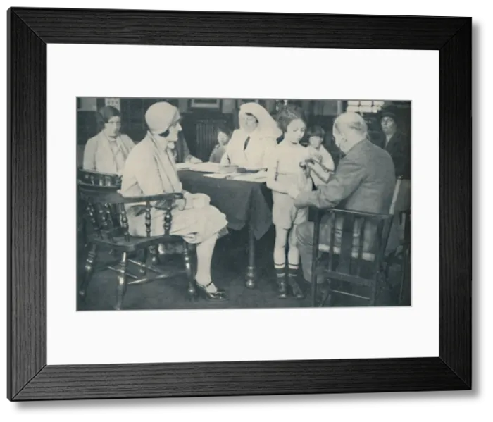Framed Print : The Doctor listening to a childs heart beat, c1935 Framed Print : The Doctor listening to a childs heart beat, c1935