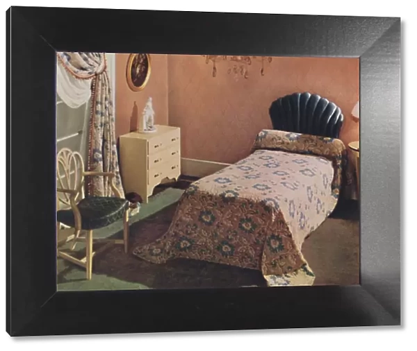 A Vantona Court bedcover gives a luxurious note to this bedroom, 1942