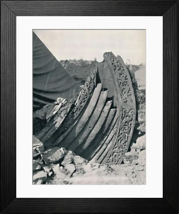 Framed Print : The Oseberg ship in the mound, showing the carving on stem and railing, 1935 Framed Print : The Oseberg ship in the mound, showing the carving on stem and railing, 1935