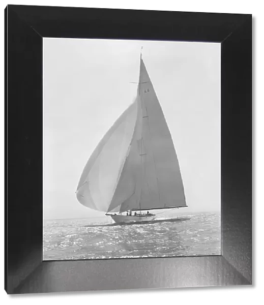 The 23 Metre Candida (K8) sailing with spinnaker, 1935. Creator: Kirk & Sons of Cowes