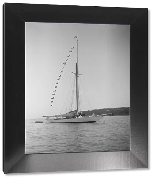 The 40-rater cutter Carina at anchor with flags, 1911. Creator: Kirk & Sons of Cowes