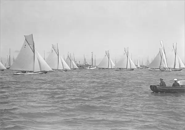 Sailing yachts cross start line. Creator: Kirk & Sons of Cowes
