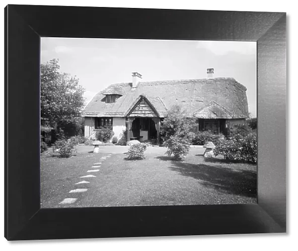 Thatched cottage and garden, c1935. Creator: Kirk & Sons of Cowes