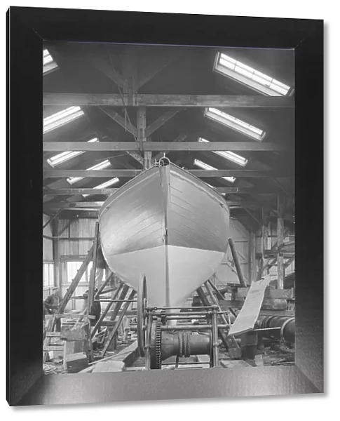 The yawl Banzai in shed at boatyard, 1912. Creator: Kirk & Sons of Cowes