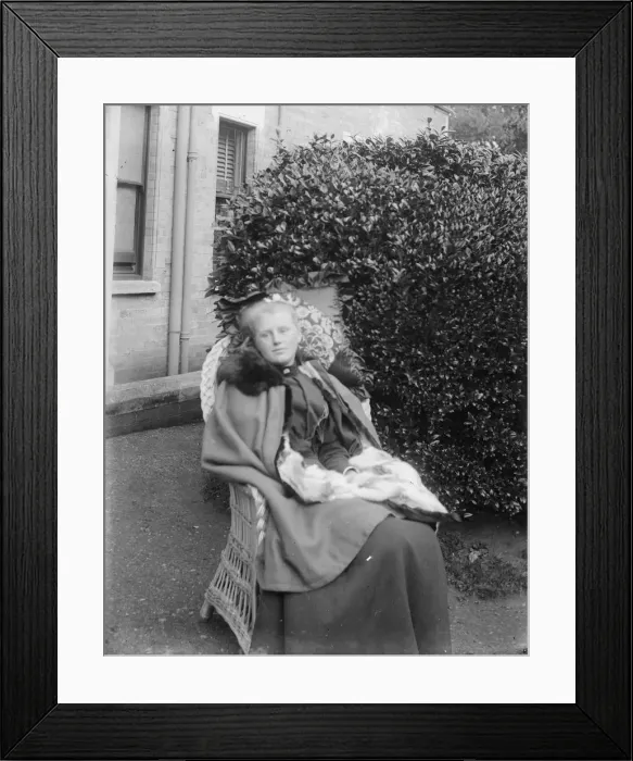Framed Print : Woman sitting in a chair in a garden, c1900. Creator: Kirk & Sons of Cowes Framed Print : Woman sitting in a chair in a garden, c1900. Creator: Kirk & Sons of Cowes