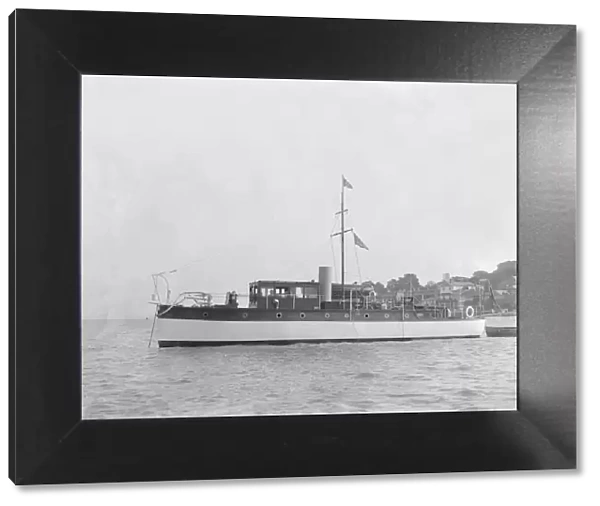 The 28 ton motor yacht Edina at anchor, 1921. Creator: Kirk & Sons of Cowes