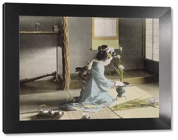 Girl arranging flowers, 1890 s. Creator: Japanese Photographer (19th Century)