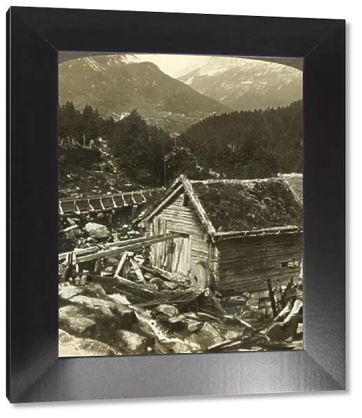 A log-built mill and a water-wheel grindstone, on Stalheims river, Naerodal, Norway, c1905