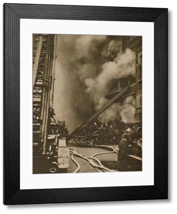 Framed Print : Subduing a Conflagration in a Narrow City Street, c1935. Creator: Unknown Framed Print : Subduing a Conflagration in a Narrow City Street, c1935. Creator: Unknown