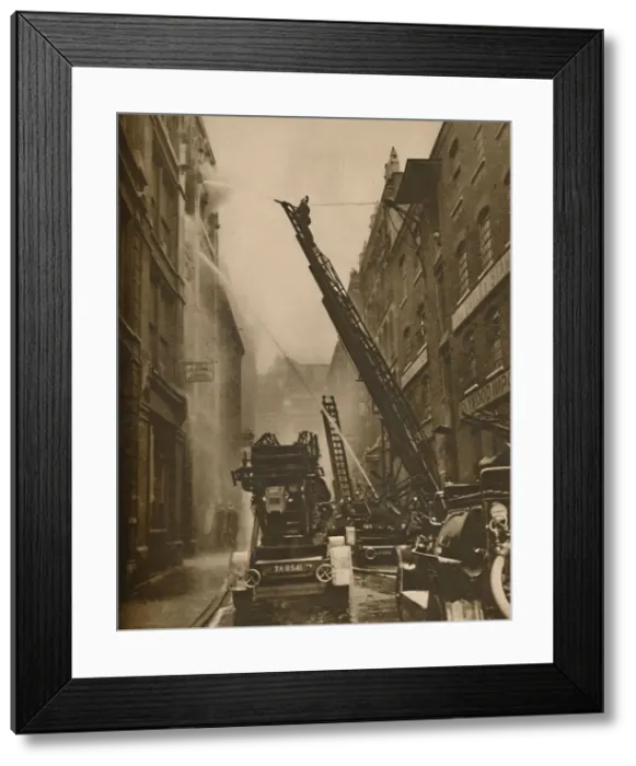 Framed Print : How The London Fire Brigade Comes To Grips With Its Enemy, c1935. Creator: Unknown Framed Print : How The London Fire Brigade Comes To Grips With Its Enemy, c1935. Creator: Unknown