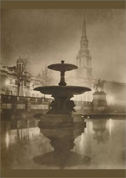 Night Rain Has Turned The Pavements To A Pool of Reflections, c1935. Creator: Calkin