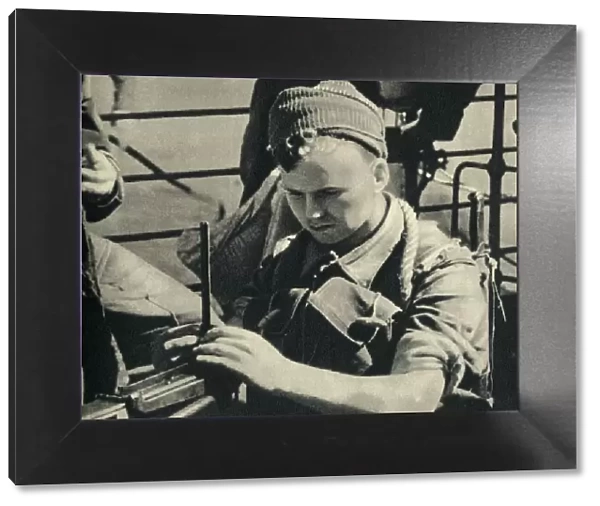 Royal Marine checking his machine gun, World War II, c1939-c1943 (1944). Creator: Unknown