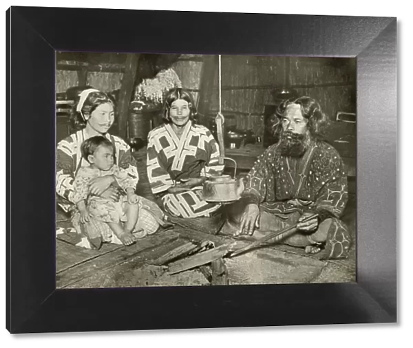 Ainu Man and Women at Home, 1910. Creator: Herbert Ponting