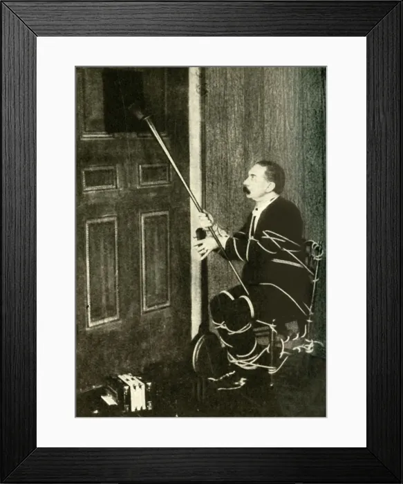 Framed Print : John Nevil Maskelyne performs a spirit cabinet illusion, c1910. Creator: Unknown Framed Print : John Nevil Maskelyne performs a spirit cabinet illusion, c1910. Creator: Unknown
