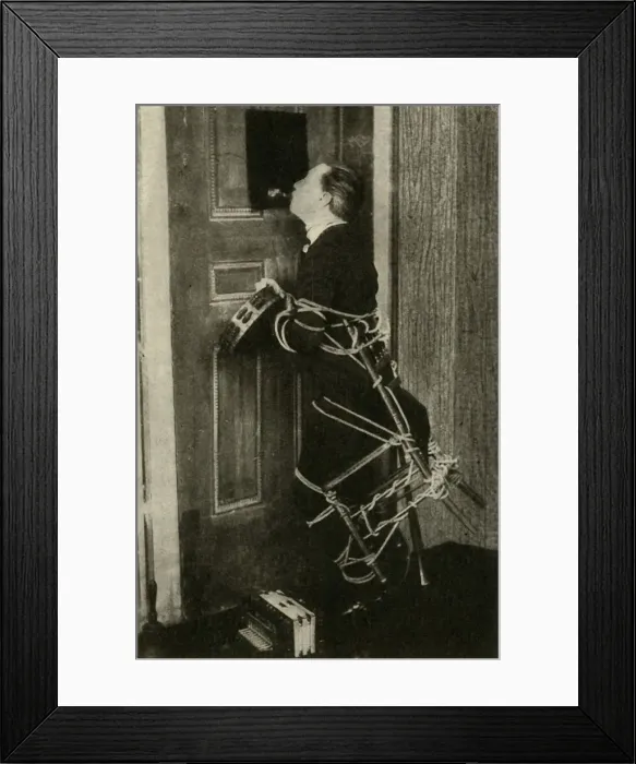 Framed Print : John Nevil Maskelyne performs a spirit cabinet illusion, c1910. Creator: Unknown Framed Print : John Nevil Maskelyne performs a spirit cabinet illusion, c1910. Creator: Unknown