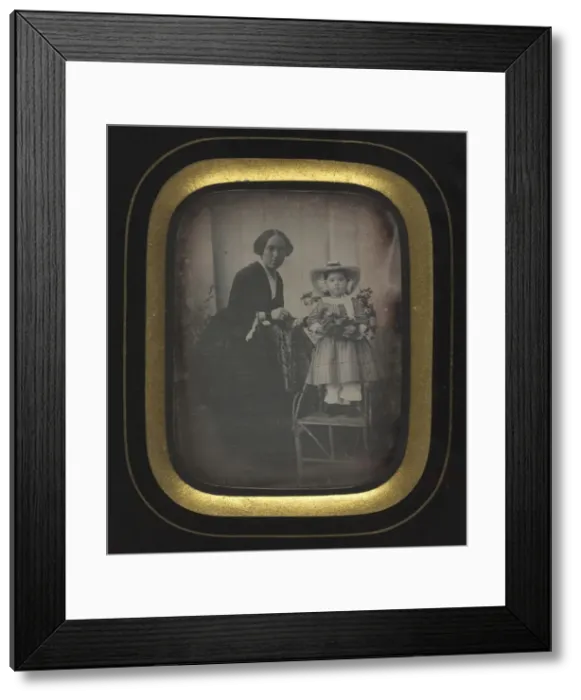 Framed Print : Child Standing on a Chair Holding Flowers, with Mother, c Framed Print : Child Standing on a Chair Holding Flowers, with Mother, c