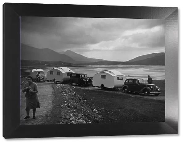 Group of cars and caravans camping in Scottish Highlands 1930 s. Creator: Unknown