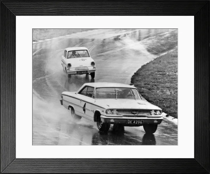 Framed Print : Ford Galaxie, J. Sears, leads Ford Anglia in wet at Brands Hatch 1963. Creator: Unknown