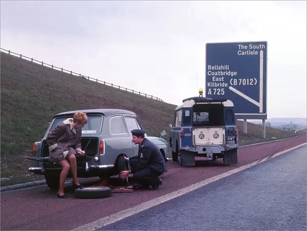Austin A40 Farina having wheel changed by R. A. C breakdown assistance. Creator: Unknown