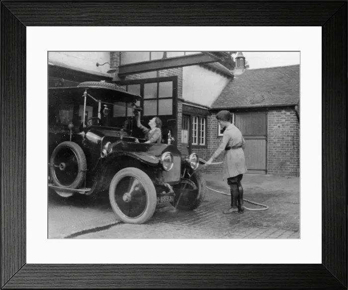 Framed Print : Chauffeuse washing car with hosepipe circa 1911. Creator: Unknown Framed Print : Chauffeuse washing car with hosepipe circa 1911. Creator: Unknown
