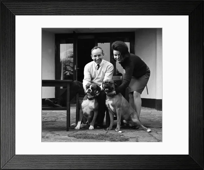 Framed Print : John Surtees relaxes at home with his wife and pet dogs in 1966. Creator: Unknown Framed Print : John Surtees relaxes at home with his wife and pet dogs in 1966. Creator: Unknown