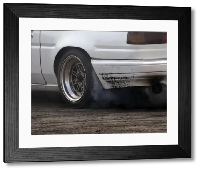 Framed Print : Smoking tyres during tyre burn-out. Creator: Unknown