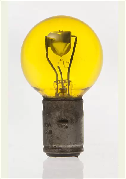 Yellow headlamp bulb. Creator: Unknown