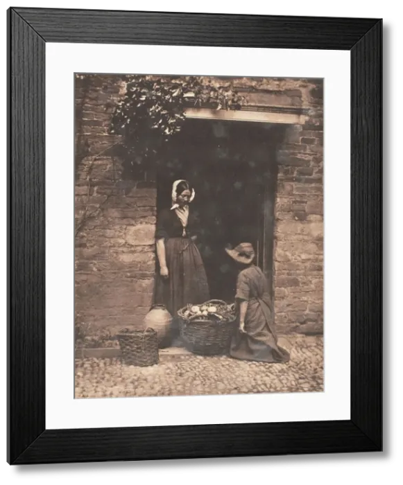 Framed Print : [Two Women, One Kneeling and One Standing, Looking into Basket Filled with Vegetables]