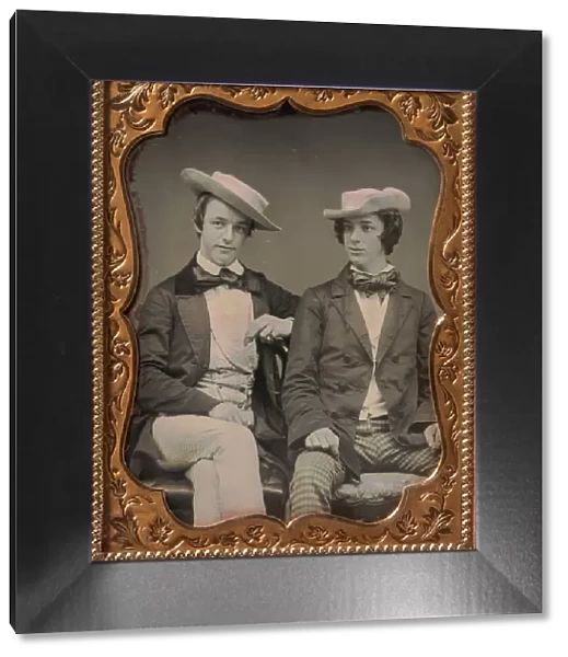 Two Seated Young Men Wearing Gingham Trousers, Bow Ties, and Brimmed, Soft Hats, 1850s