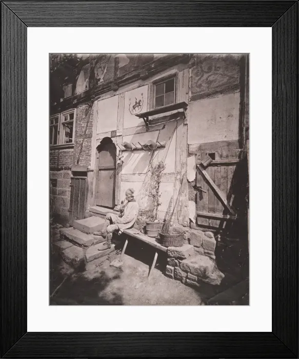 Framed Print : [Man Smoking Pipe Outside His Home on Village Street], 1880s. Creator: Unknown