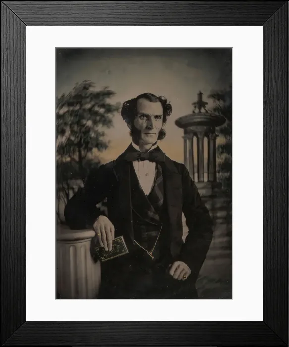 Framed Print : Man Holding Book, Standing Before a Painted Scenic Backdrop, 1850s-60s. Creator: Unknown Framed Print : Man Holding Book, Standing Before a Painted Scenic Backdrop, 1850s-60s. Creator: Unknown