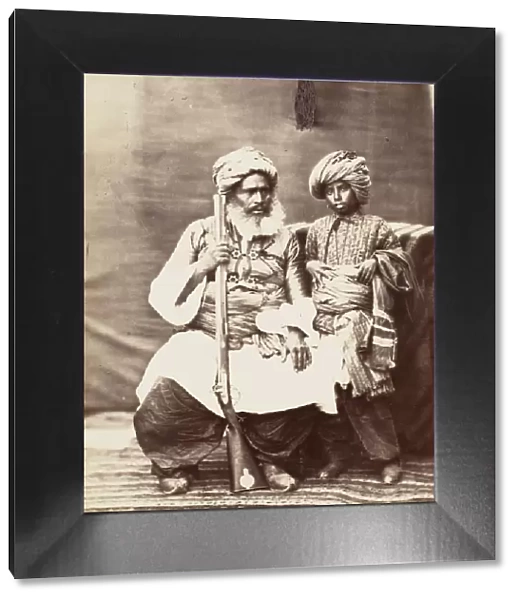 Turbaned Man Holding Rifle with Boy Alongside, 1860s. Creator: Unknown