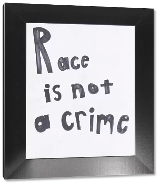 Poster reading 'Race is not a crime'used at Baltimore protests, April 2015