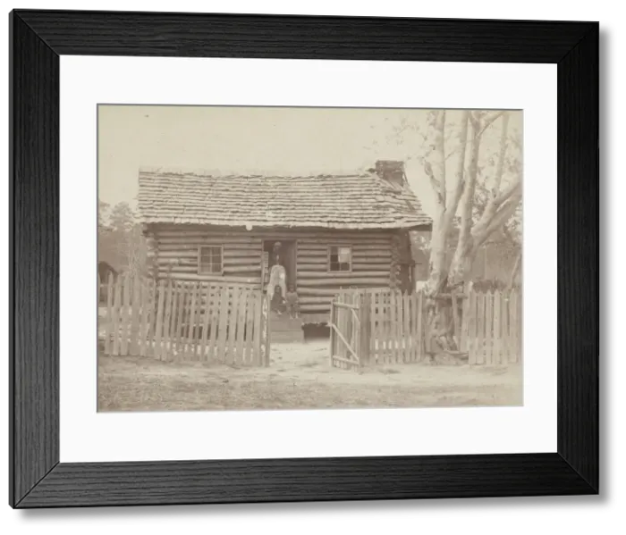 Framed Print : Albumen print of a woman and two children in front of a log house in Georgia, 1880s Framed Print : Albumen print of a woman and two children in front of a log house in Georgia, 1880s