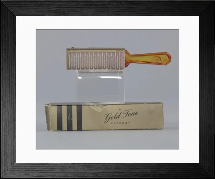 Framed Print : Plastic brush with box from Maes Millinery Shop, 1941-1994. Creator: Gold Tone
