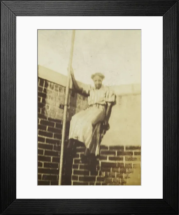 Framed Print : Photographic print of a woman on a brick wall, early 20th century. Creator: Unknown Framed Print : Photographic print of a woman on a brick wall, early 20th century. Creator: Unknown