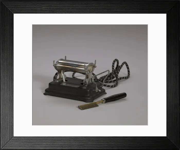 Framed Print : Electrical hot comb heater and hot comb, 1920s. Creator: Unknown Framed Print : Electrical hot comb heater and hot comb, 1920s. Creator: Unknown