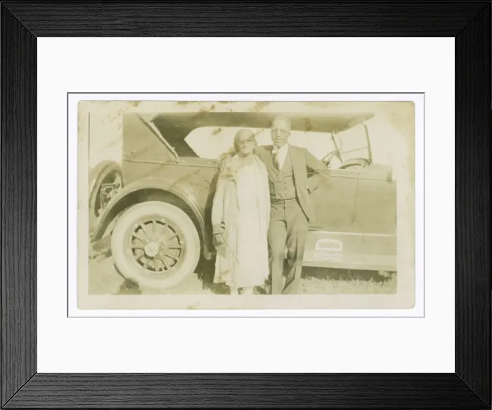 Framed Print : Photograph of a man and woman in front of car, ca. 1921. Creator: Unknown Framed Print : Photograph of a man and woman in front of car, ca. 1921. Creator: Unknown