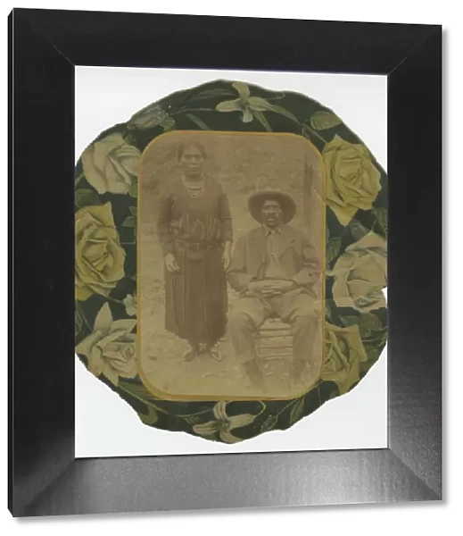 Photographic portrait of a man and woman on floral paper backing, early 20th century