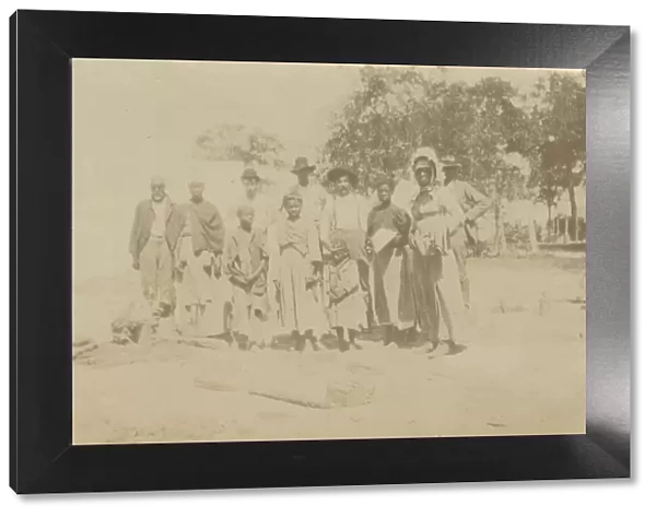 Photograph of men, women, and children in a yard, early 20th century. Creator: Unknown