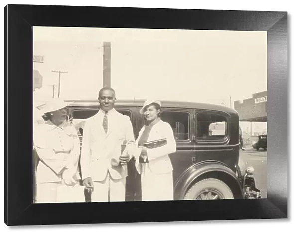 Photographic print of Mr. and Mrs. Jackson and another woman in front of car, 1926