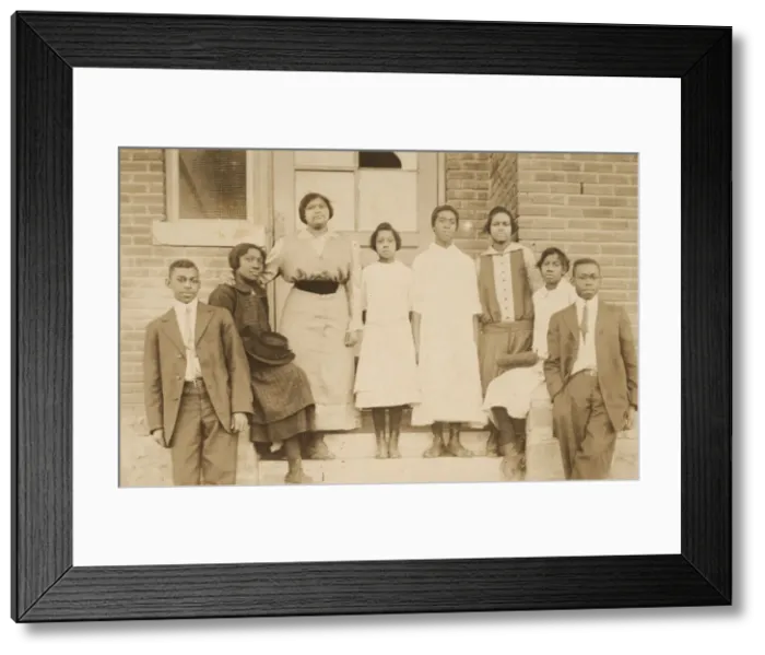 Framed Print : Photographic print of 8 people in front of a building, 1904-1918. Creator: Unknown Framed Print : Photographic print of 8 people in front of a building, 1904-1918. Creator: Unknown