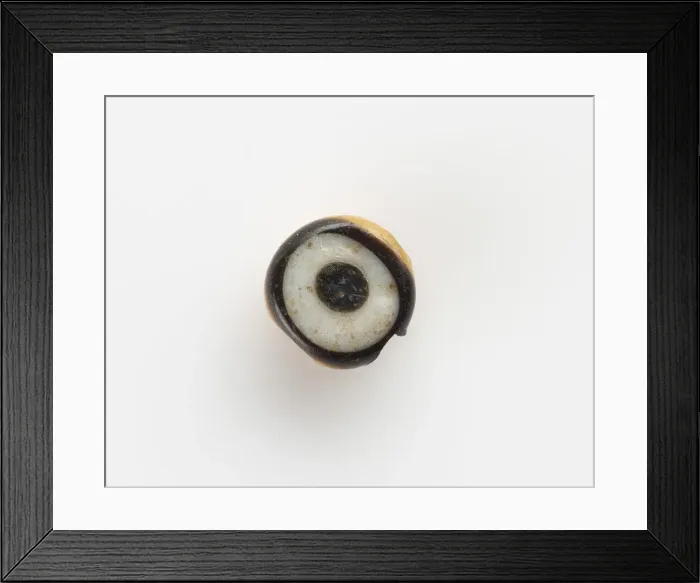 Framed Print : Eye-bead, with a lateral bore; the eyelet broken off, New Kingdom, 1550-1307 BCE Framed Print : Eye-bead, with a lateral bore; the eyelet broken off, New Kingdom, 1550-1307 BCE