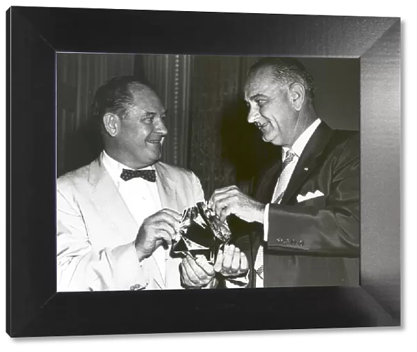 T. Keith Glennan shows Lyndon Johnson aluminized mylar flim used to make the Echo I